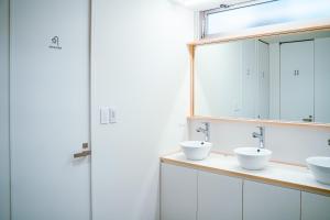 Un baño con dos lavabos y un espejo. en UNPLAN Kagurazaka, en Tokio