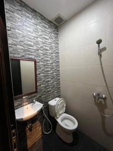 a bathroom with a toilet and a sink at The Cabin Tanjung Yogyakarta in Yogyakarta +19 photos