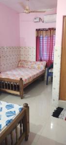 a bedroom with two beds in a room at Happy Tourist Home Neyyardam in Parattipalli