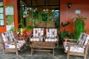 two chairs and a table in a room with plants at Fundo San Jose Parque Ecológico & Lodge Hotel Asociado Casa Andina in La Merced