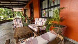 a porch with two chairs and a plant at Fundo San Jose Parque Ecológico & Lodge Hotel Asociado Casa Andina in La Merced +140 photos