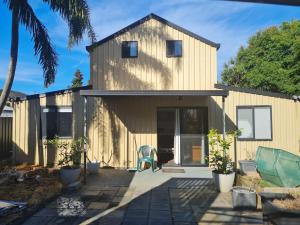a house with a patio in front of it at Fully Self Contained Guesthouse Retreat in Fishing Point