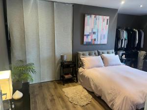 a bedroom with a white bed and a large window at Spacious 2 Bed Ribble Valley Apartments in Blackburn