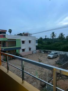 a car parked in a parking lot next to a building at Gugan home stay in Tiruchchendūr