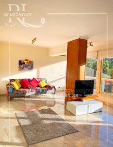 a living room with a couch and a tv at Lovely gorgeous apartment among green Maadi in Cairo