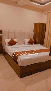 a bedroom with a large bed with the word excellence written on it at Hotel shivansh Residency in Rishīkesh +2 photos