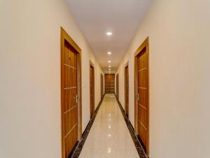 a corridor with wooden doors in a building at Hotel O B.S Celebration in Lucknow
