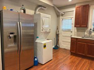 a kitchen with a stainless steel refrigerator and a sink at Kelly Lodging in Baltimore