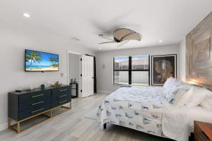 a bedroom with a bed and a dresser and a window at Marco Island Beach Home - Heated Pool & Spa in Marco Island