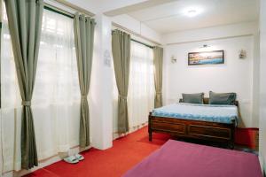 a bedroom with a bed and a window at HoneyBell Homestay in Darjeeling