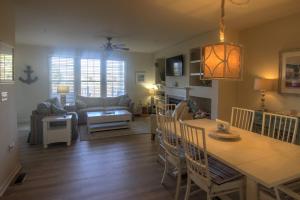 a kitchen and living room with a table and chairs at 128E October Glory Ave, Ocean View in Ocean View