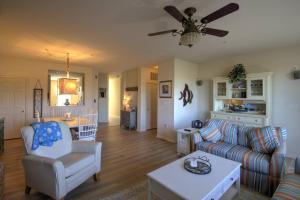 a living room with a couch and a ceiling fan at 128E October Glory Ave, Ocean View in Ocean View