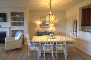 a kitchen and dining room with a table and chairs at 128E October Glory Ave, Ocean View in Ocean View