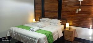 een slaapkamer met een bed met twee kussens erop bij Menoreh Farm Stay Samigaluh Kulonprogo in Kalirejo