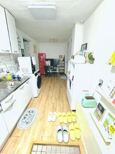 a kitchen with white appliances and a wooden floor at OpenSale Sinchon station, 1F, 4ppl, 2BR, Hongdae, Private in Seoul