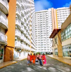 a group of people standing in a street in front of buildings at SweetLove Hideaway CITYLAND Condo 2-BR, 2-Bath, Living room, Sleeps 12, Kitchen, Free Pool, Wi-Fi, 2 Parking, View-Deck on 24F rooftop in Iruhin +192 photos