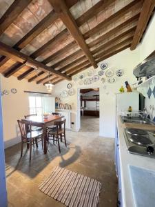 a kitchen and dining room with a table and chairs at Agriturismo Montesalce in Gubbio