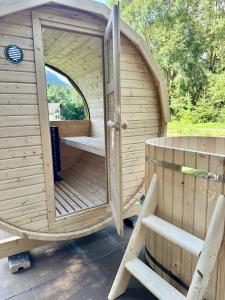 a wooden sauna with an open door and a bench at KAPINA sk - Dom Jasna in Liptovský Mikuláš