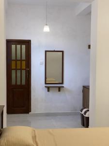 a mirror on the wall of a bedroom at Misty Clouds Homestay in Kandy +68 photos