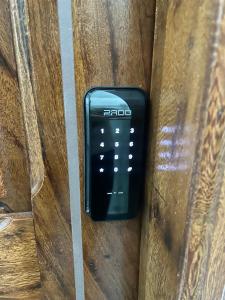 a black remote control sitting on a wooden bench at Cantinho da Bandeira in Belém