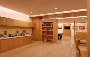 a large room with a kitchen and a dining room at Hotel Red Plaza -Near Delhi Airport & Free Airport Drop in New Delhi