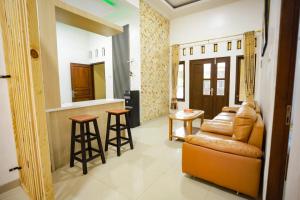een woonkamer met een bank en een keuken bij O2 Jogja Villa in Salakan