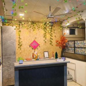 an office with a wall covered in ivy at Malwade Motel in Pune