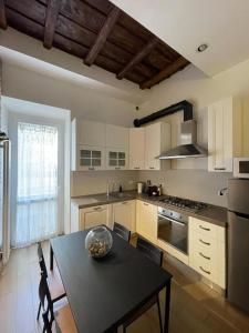 a kitchen with a table and a stove top oven at La bella Flora in Ariccia