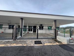a building with a gate in front of it at Hasya Guesthouse in Seri Iskandar