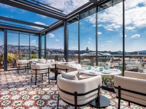 a dining room with a view of the city at Swissôtel Tbilisi in Tbilisi City