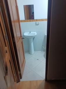 a bathroom with a sink and a toilet at Hostal JM in Huancayo