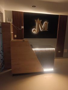 a room with a sign on the wall and a desk at Hostal JM in Huancayo