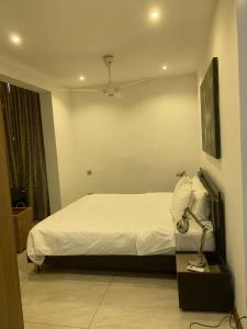 ein Schlafzimmer mit einem Bett und einer Lampe auf einem Tisch in der Unterkunft Crown Luxury Apartment 2 Bed Room Apartment in Colombo