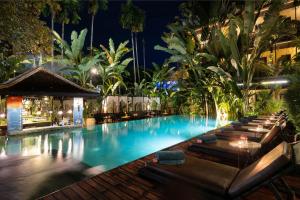 a swimming pool at night with a resort at Residence Indochine Suite in Siem Reap