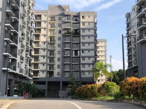 a tall apartment building with a street in front of it at Viyathpura in Nikawatawana