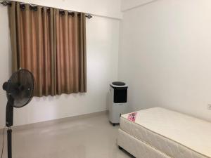 a small room with a bed and a fan at Viyathpura in Nikawatawana