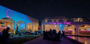 a group of people sitting in chairs in front of a building at Lushy Hostel Kintamani in Kubupenlokan