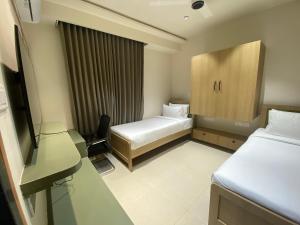 Ένα ή περισσότερα κρεβάτια σε δωμάτιο στο Sasya Elegance - A Boutique Hotel