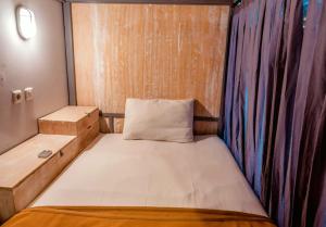 a small room with a bed and a curtain at Lushy Hostel Kintamani in Kubupenlokan +22 photos