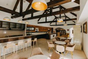 a restaurant with tables and chairs and a bar at Wine & boutique hotel Terbotz in Štrigova +6 photos