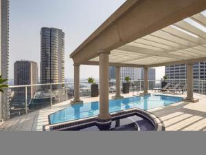 a swimming pool on the roof of a building at Mantra 2 Bond Street in Sydney