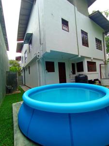 a large blue frisbee in front of a house at Villa Piore in Mirissa