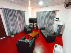 a living room with two couches and a television at Villa Piore in Mirissa