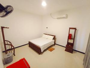 a bedroom with a bed and a mirror in it at Villa Piore in Mirissa +34 photos