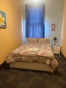 a bedroom with a bed with a blue curtain at Commercial Hotel Dowerin in Dowerin
