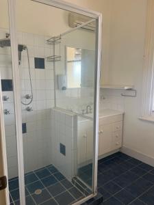 a bathroom with a shower and a sink at Commercial Hotel Dowerin in Dowerin