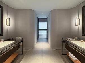 a bathroom with two sinks and two mirrors at Ananti at Busan Village in Busan