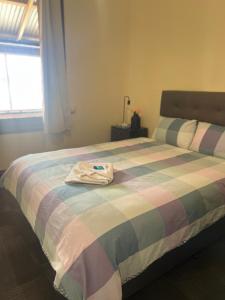 a room with a bed with a shirt on it at Commercial Hotel Dowerin in Dowerin +6 photos