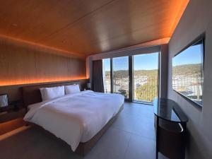 Ένα ή περισσότερα κρεβάτια σε δωμάτιο στο Ananti at Busan Village