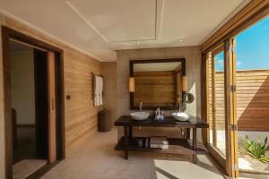 a bathroom with a sink and a mirror at Nala Maldives by Jawakara in Lhaviyani Atoll